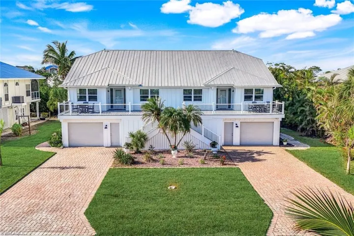 View of front of home with a front yard and a garage