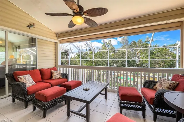 Sunroom featuring ceiling fan and vaulted ceiling
