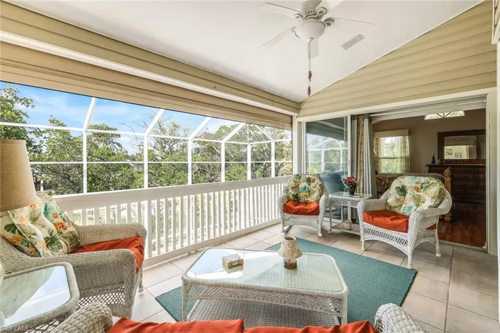 Sunroom / solarium with a wealth of natural light, ceiling fan, and vaulted ceiling