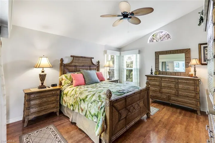 Bedroom featuring vaulted ceiling, ceiling fan, and dark hardwood / wood-style floors