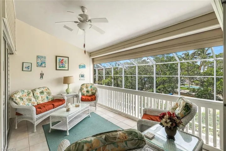 Sunroom with ceiling fan and vaulted ceiling