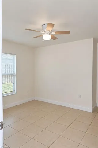 Recessed lighting, ceiling fan with light fixture, tiled flooring, and a single window