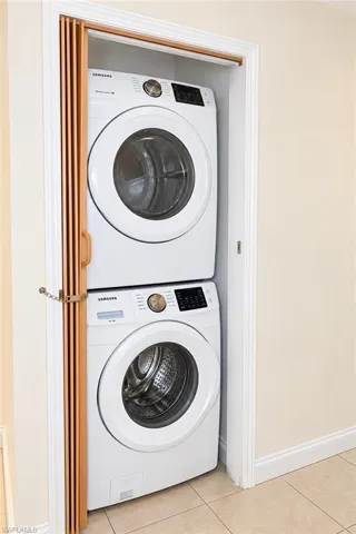 Stacked washer and dryer unit, accordion closet door, and tiled flooring