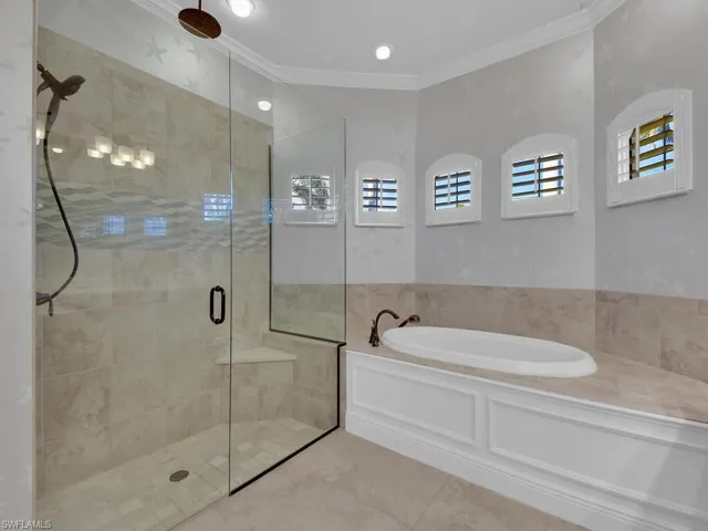 Master Bathroom featuring tile patterned flooring, shower with separate bathtub, and ornamental molding