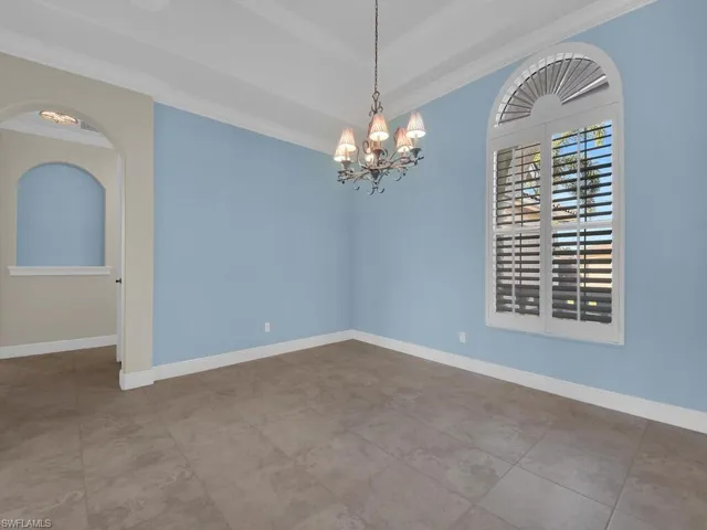 Dining room featuring a notable chandelier and crown molding