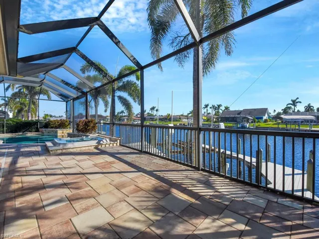 View of patio / terrace featuring a pool with hot tub, a lanai, and a water view