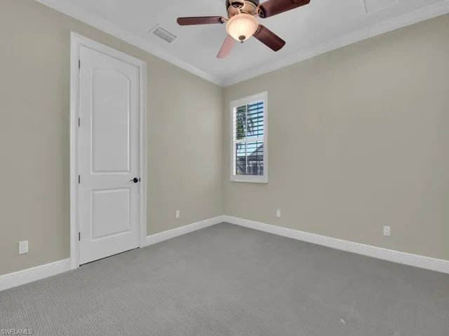 2nd ground floor guest with on suite full bath room featuring crown molding, light carpet, and ceiling fan