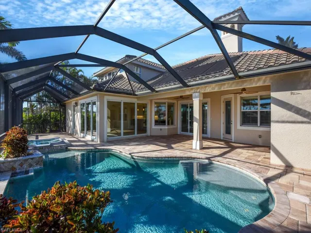 View of pool featuring a lanai, a patio, ceiling fan, and an in ground hot tub