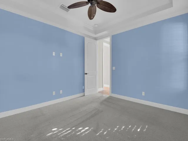 Carpeted Ground floor guest room featuring crown molding and ceiling fan