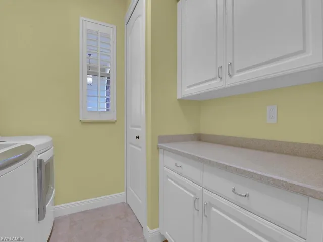 Clothes washing area with cabinets and independent washer and dryer