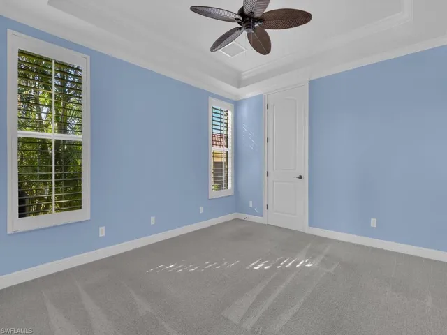 Ground floor Guest room and attached Bath with crown molding, ceiling fan, a raised ceiling, and carpet