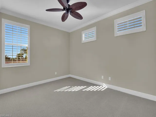 Carpeted 3rd guest room room with ceiling fan and ornamental molding