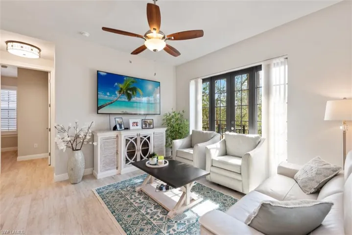Living area with a ceiling fan and wood finished floors
