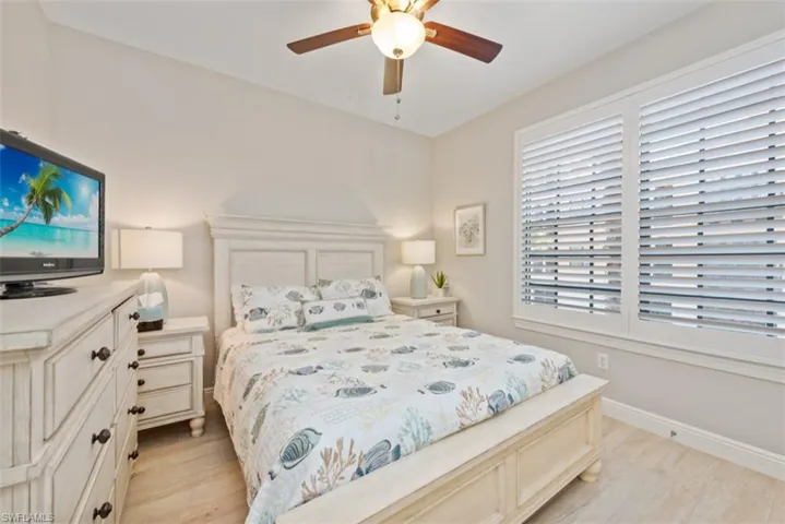 Bedroom with a ceiling fan and light wood-style flooring