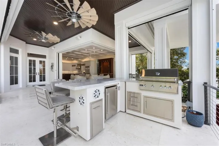View of patio / terrace with exterior kitchen, french doors, and a ceiling fan