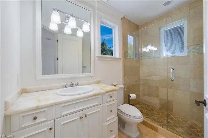 Full bath featuring vanity and a shower stall