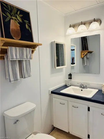 Half bath with vanity and toilet