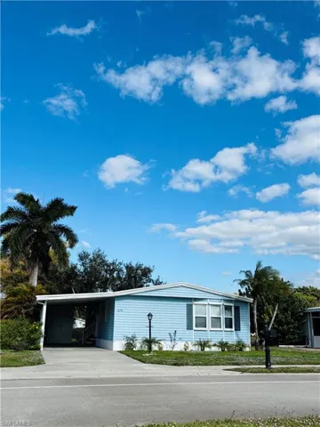 Manufactured / mobile home with a carport and concrete driveway