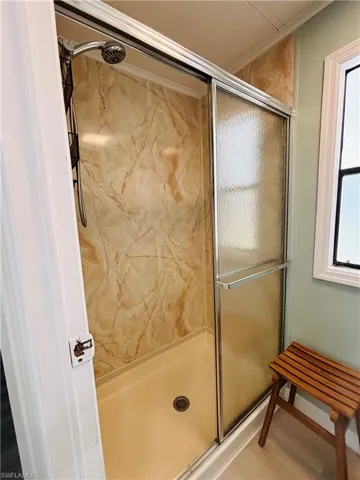 Full bathroom featuring a shower stall