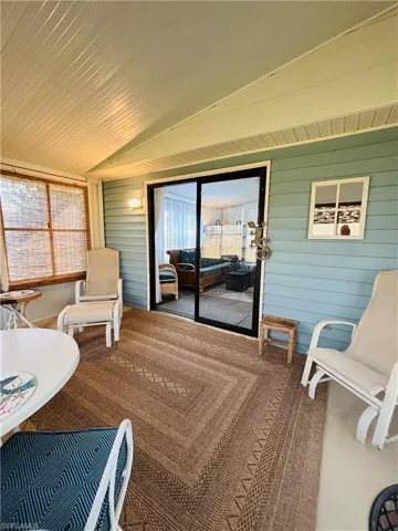 Sunroom / solarium featuring vaulted ceiling