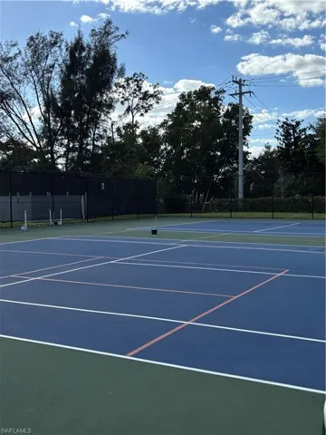 View of tennis court featuring community basketball court