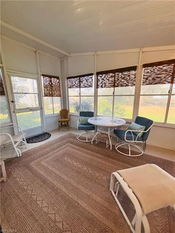 Sunroom with carpet flooring and plenty of natural light