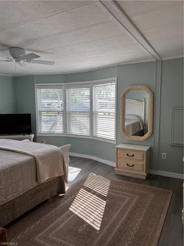 Bedroom featuring dark wood-type flooring and a ceiling fan