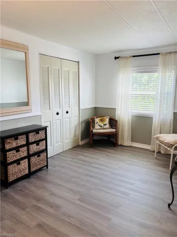 Sitting room with light wood-style floors and baseboards