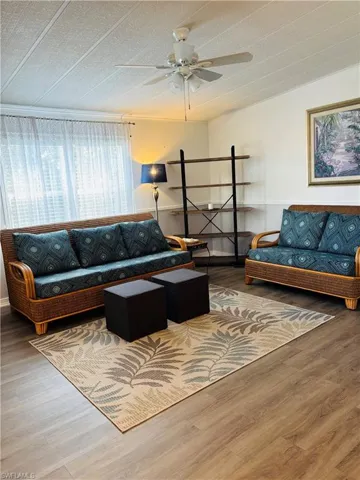 Living room featuring wood finished floors and ceiling fan
