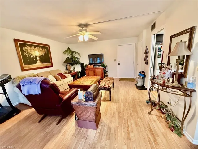 Living room featuring light wood-style floors and ceiling fan
