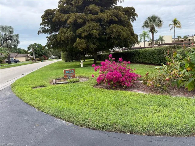View of property's community featuring a lawn