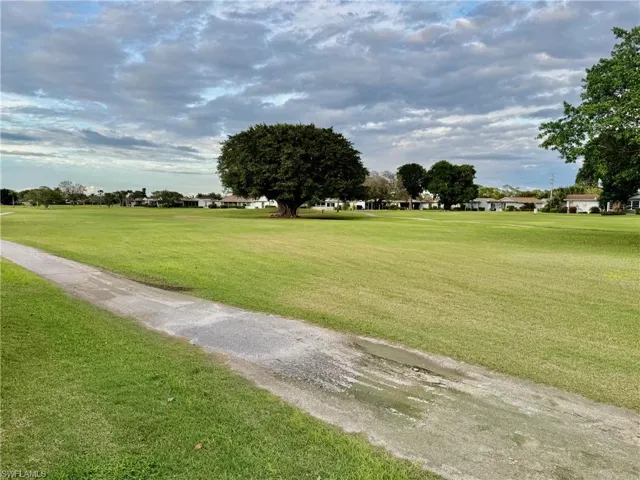 View of property's community with a lawn
