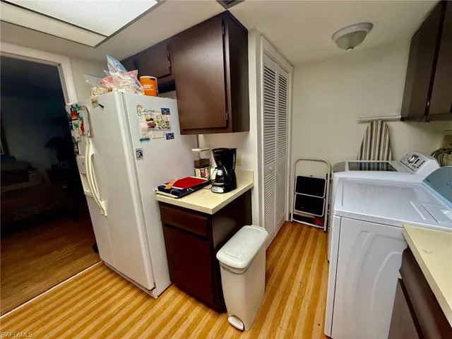 Washroom featuring independent washer and dryer and light wood finished floors