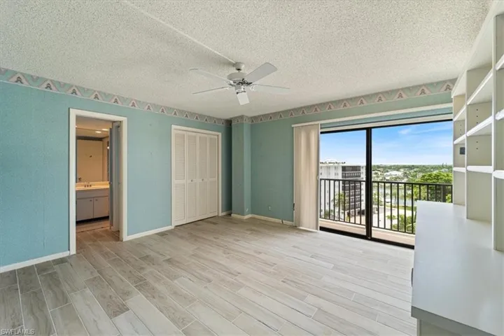 Unfurnished bedroom with access to exterior, light wood-type flooring, a textured ceiling, ceiling fan, and a closet
