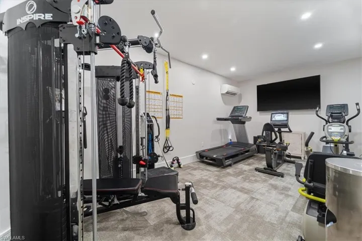 Workout room featuring light colored carpet and recessed lighting
