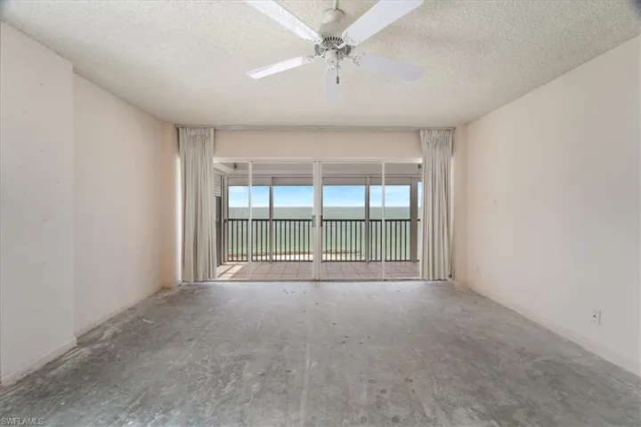 Empty room featuring a textured ceiling and a ceiling fan