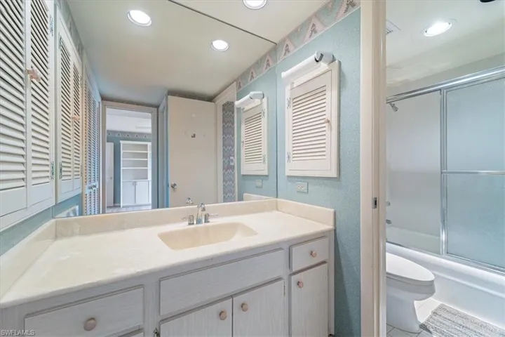 Full bathroom with vanity, combined bath / shower with glass door, tile patterned flooring, and recessed lighting