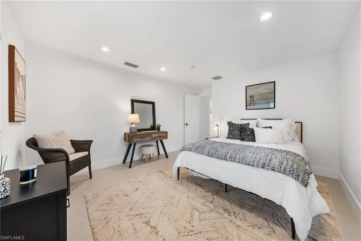 Bedroom with recessed lighting and light tile patterned floors