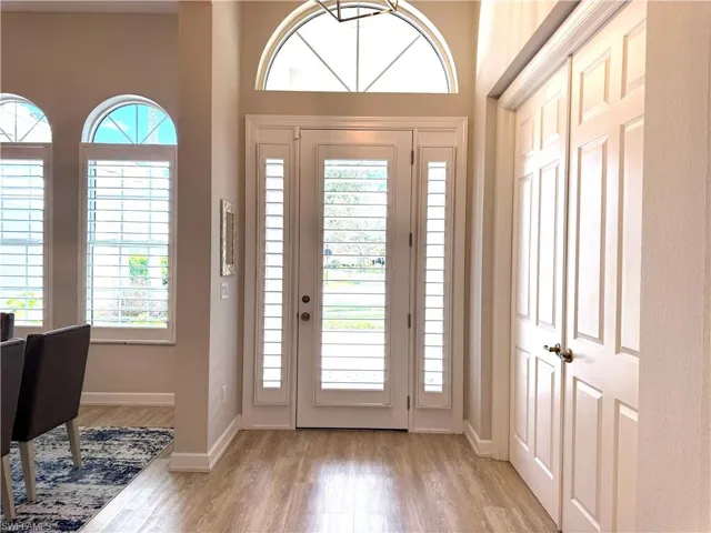 Entrance foyer with plenty of natural light and light wood-style flooring