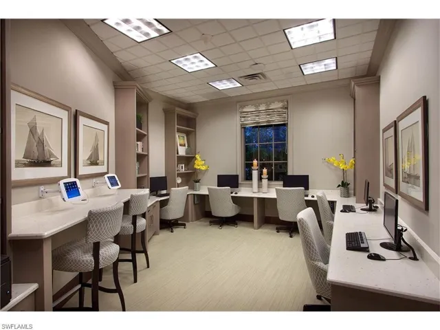 Office featuring built in study area, a drop ceiling, and crown molding
