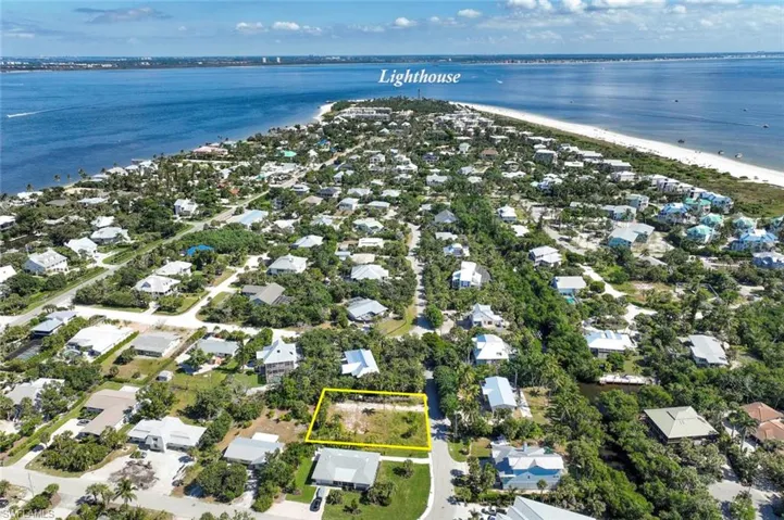 Aerial overview of property's location with property parcel outlined and nearby suburban area