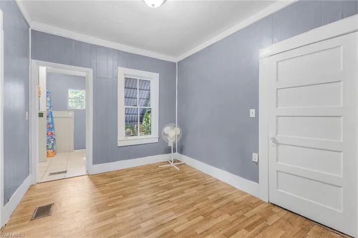 Entryway with crown molding and light tile patterned floors