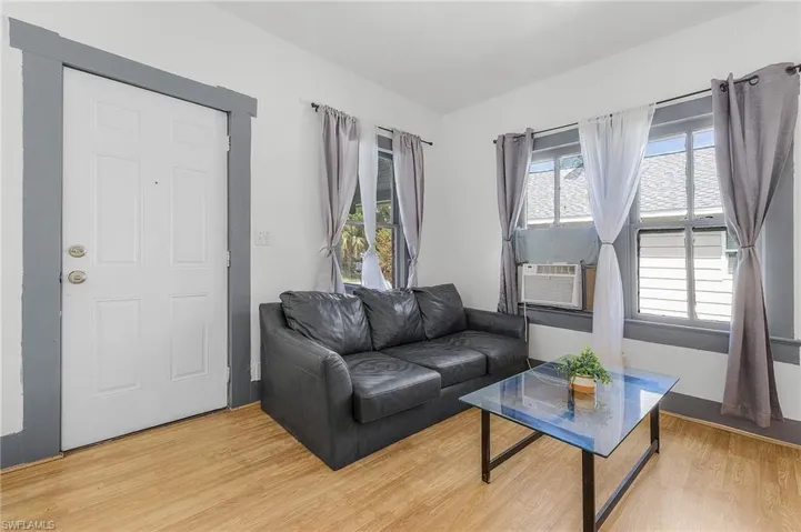 Living room featuring plenty of natural light, light hardwood / wood-style flooring, and cooling unit