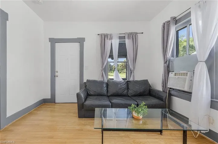 Living room with a wealth of natural light and light hardwood / wood-style floors