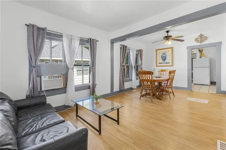 Living room with ceiling fan, light wood-type flooring, and cooling unit