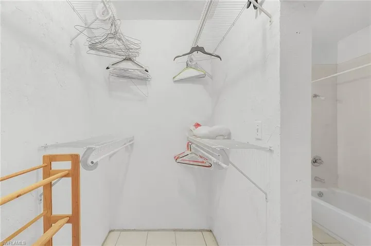 Walk in closet with light tile patterned flooring