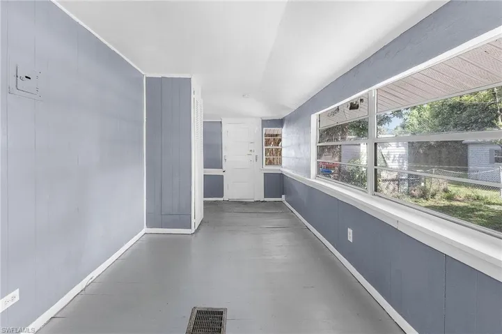 Unfurnished sunroom with lofted ceiling