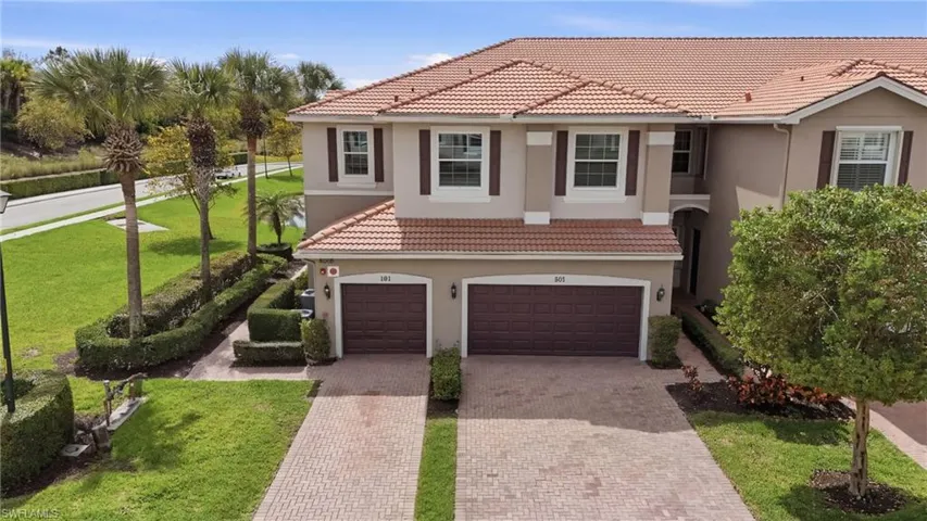 End unit carriage home with attached garage and private side entry..