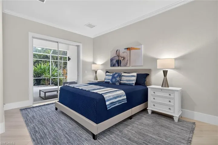 Bedroom with crown molding, access to exterior, and light wood finished floors