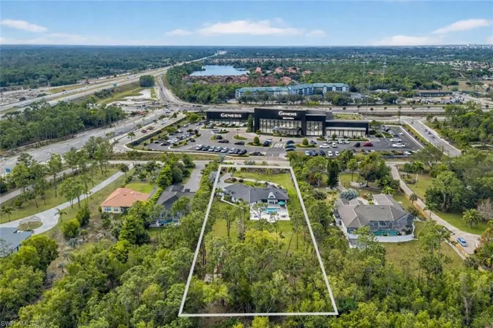 Aerial view of property's location with property parcel outlined and a large body of water